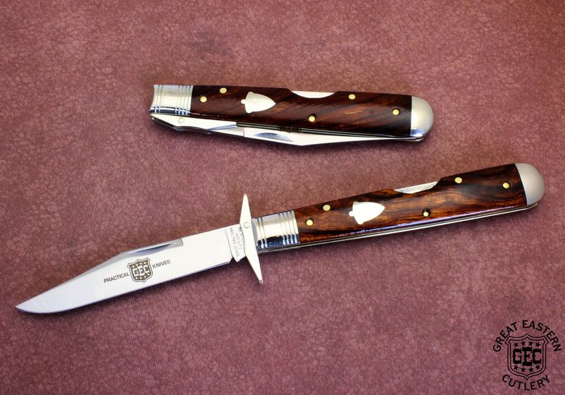 A GEC Practical Knives swing-guard lockback with polished rosewood handle, open beside a second closed knife